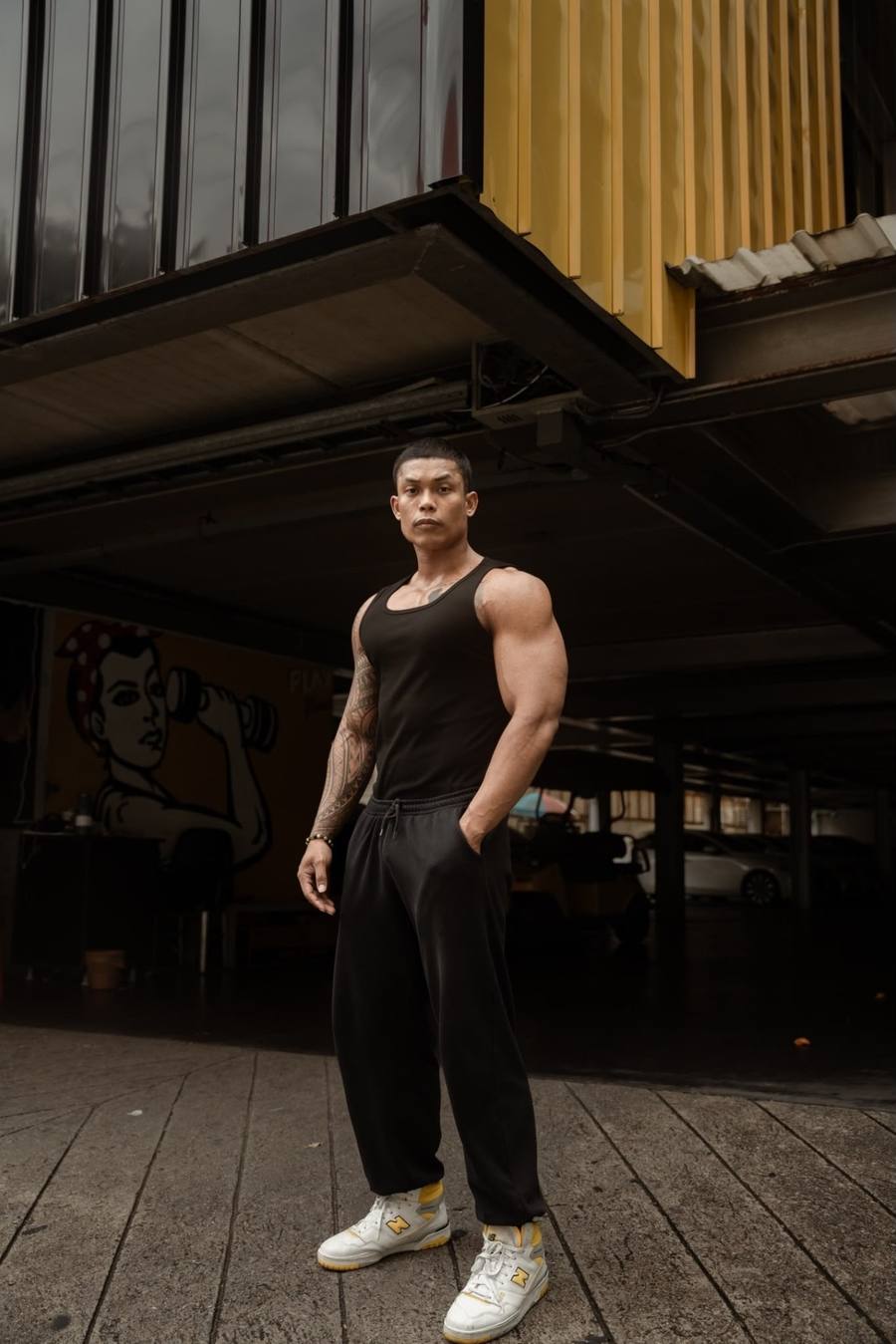 Coach Kanoon in black training gear on a Bangkok street