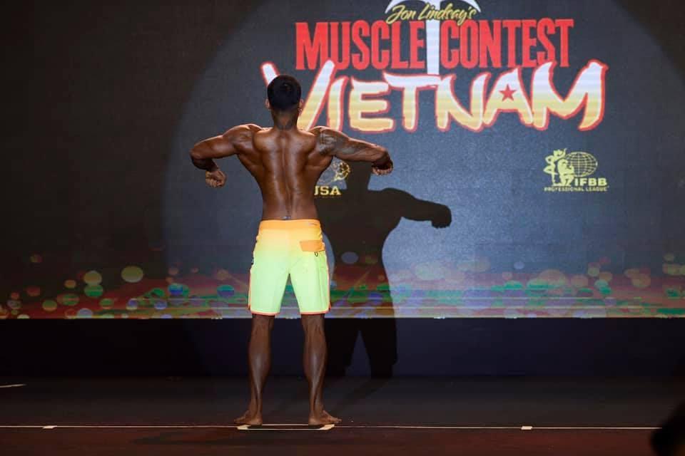Kanoon posing on stage at Muscle Contest Vietnam